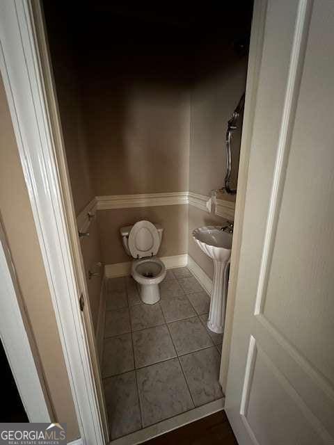 8010 Scudder Way, Ball Ground, GA 30107 - bathroom with toilet, tile patterned flooring, a sink, and baseboards