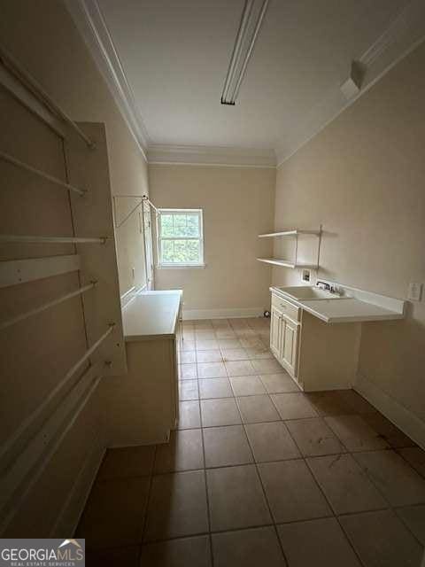 8010 Scudder Way, Ball Ground, GA 30107 - clothes washing area with ornamental molding, a sink, light tile patterned floors, and baseboards