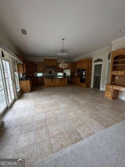 8010 Scudder Way, Ball Ground, GA 30107 - kitchen with light tile patterned floors, brown cabinets, ornamental molding, dark countertops, and visible vents