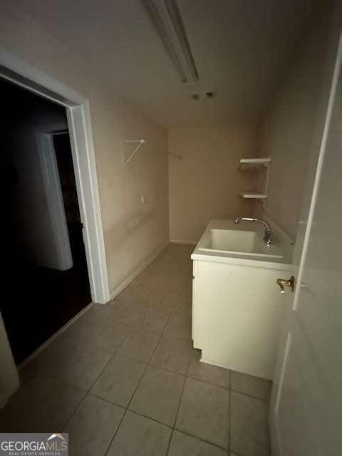 8010 Scudder Way, Ball Ground, GA 30107 - laundry area featuring a sink and light tile patterned floors