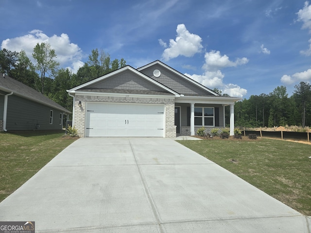 view of front of property featuring an attached garage, concrete driveway, brick siding, and a front yard
