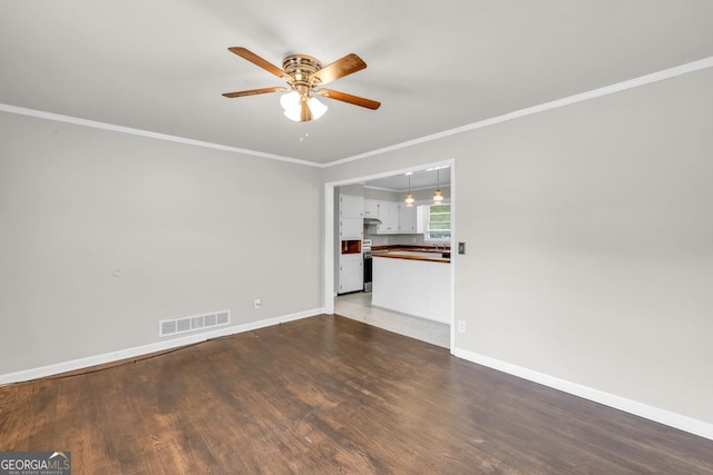 98 Orchard Cir, Commerce, GA 30529 - spare room featuring visible vents, baseboards, ornamental molding, wood finished floors, and a ceiling fan