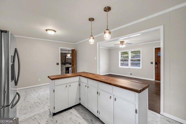 98 Orchard Cir, Commerce, GA 30529 - kitchen with marble finish floor, ceiling fan, wooden counters, and stainless steel fridge