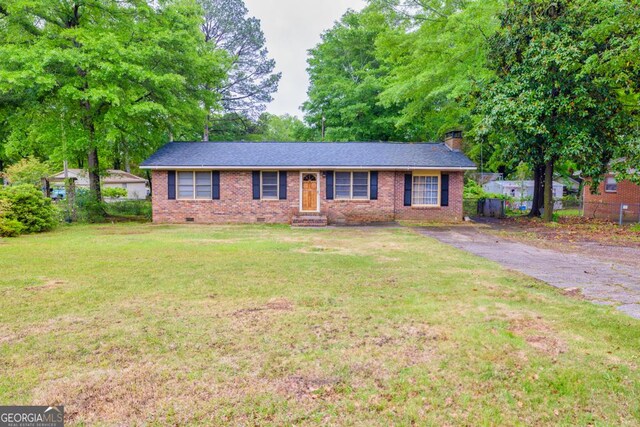 98 Orchard Cir, Commerce, GA 30529 - ranch-style house featuring a front lawn, a chimney, brick siding, entry steps, and fence