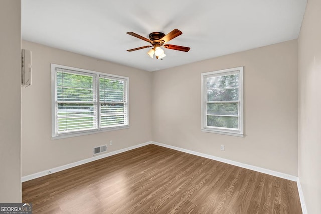 98 Orchard Cir, Commerce, GA 30529 - unfurnished room featuring wood finished floors, visible vents, ceiling fan, and baseboards