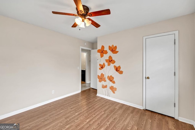 98 Orchard Cir, Commerce, GA 30529 - unfurnished room with wood finished floors, ceiling fan, and baseboards