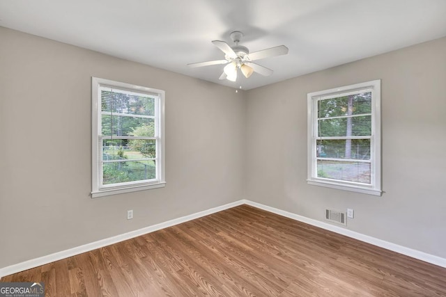 98 Orchard Cir, Commerce, GA 30529 - spare room with baseboards, visible vents, and wood finished floors