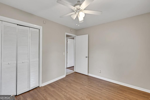 98 Orchard Cir, Commerce, GA 30529 - unfurnished bedroom with ceiling fan, a closet, light wood finished floors, and baseboards