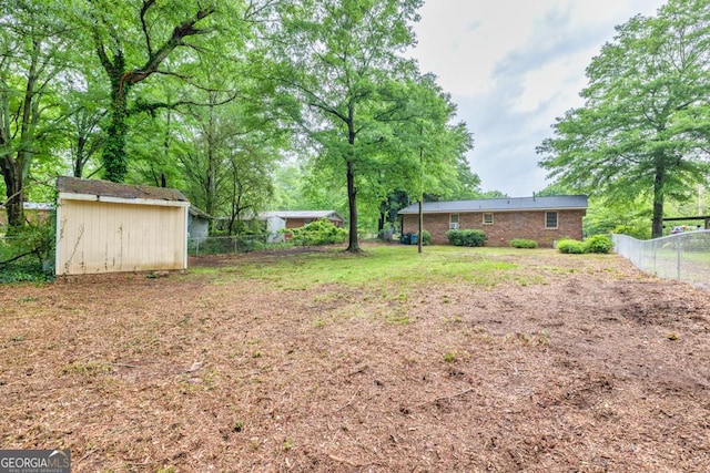 98 Orchard Cir, Commerce, GA 30529 - view of yard featuring fence, an outdoor structure, and a storage shed