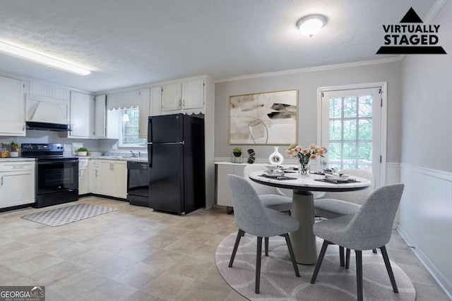 3664 Satellite Ter, Ellenwood, GA 30294 - kitchen with white cabinets, black appliances, light countertops, premium range hood, and ornamental molding