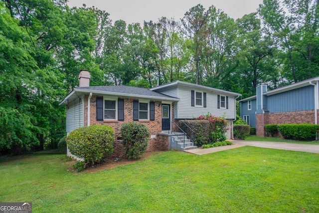 3664 Satellite Ter, Ellenwood, GA 30294 - tri-level home featuring a chimney, a front yard, brick siding, and driveway