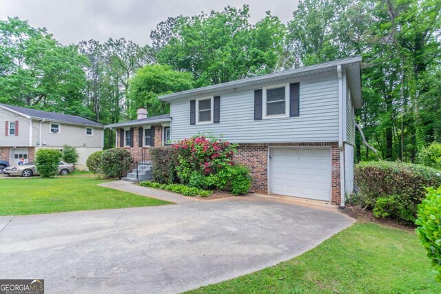 3664 Satellite Ter, Ellenwood, GA 30294 - split level home with brick siding, concrete driveway, a garage, a front yard, and a chimney