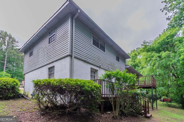 3664 Satellite Ter, Ellenwood, GA 30294 - view of side of home featuring a deck, stairs, and stucco siding