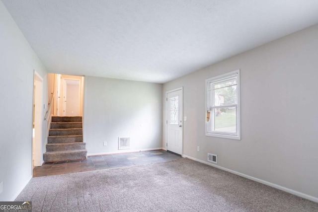 3664 Satellite Ter, Ellenwood, GA 30294 - unfurnished living room with stairs, carpet floors, baseboards, and visible vents