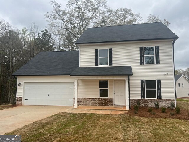68 Davis Lake Rd Lot 16, Thomaston, GA 30286 - traditional-style home featuring concrete driveway, covered porch, brick siding, a front lawn, and a garage