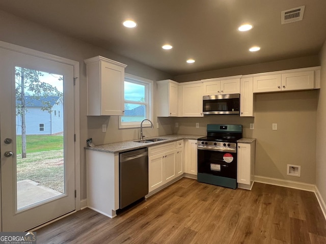 68 Davis Lake Rd Lot 16, Thomaston, GA 30286 - kitchen featuring a sink, visible vents, white cabinets, appliances with stainless steel finishes, and wood finished floors