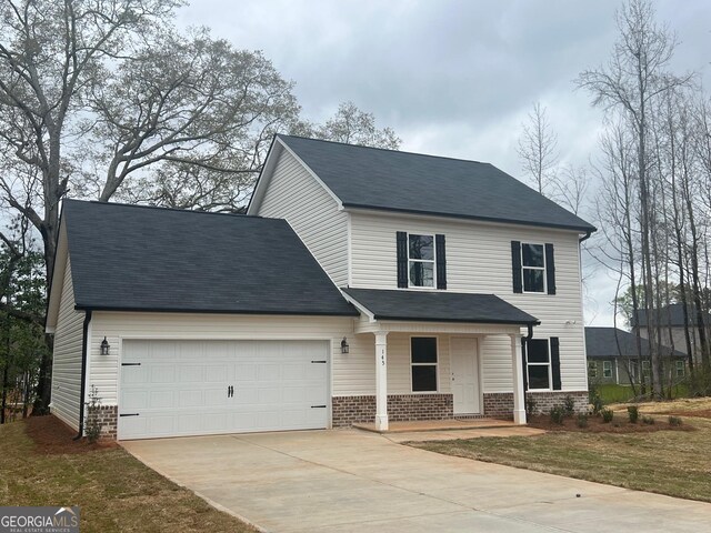 68 Davis Lake Rd Lot 16, Thomaston, GA 30286 - traditional-style home with driveway, an attached garage, a porch, and brick siding