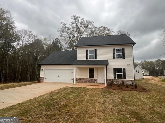68 Davis Lake Rd Lot 16, Thomaston, GA 30286 - traditional home featuring concrete driveway, a garage, a front lawn, and brick siding