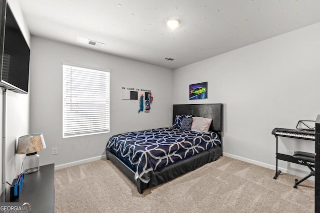 carpeted bedroom featuring visible vents and baseboards