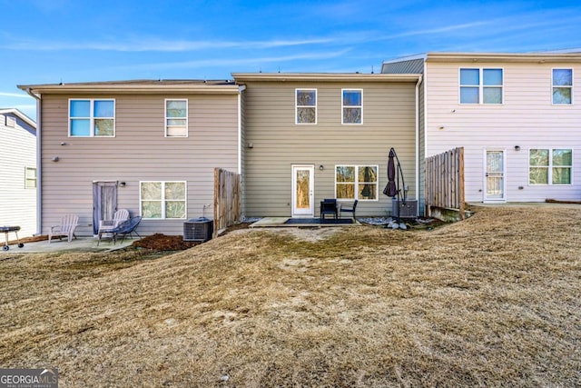back of property featuring a patio, a lawn, and central air condition unit