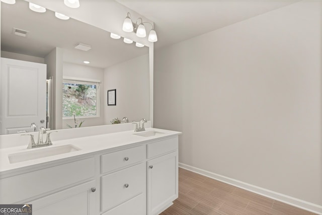 full bath featuring a sink, baseboards, double vanity, and visible vents