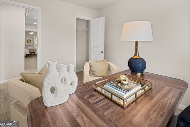 living area featuring baseboards and carpet