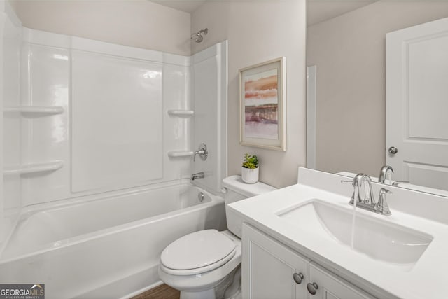 bathroom featuring vanity, washtub / shower combination, and toilet