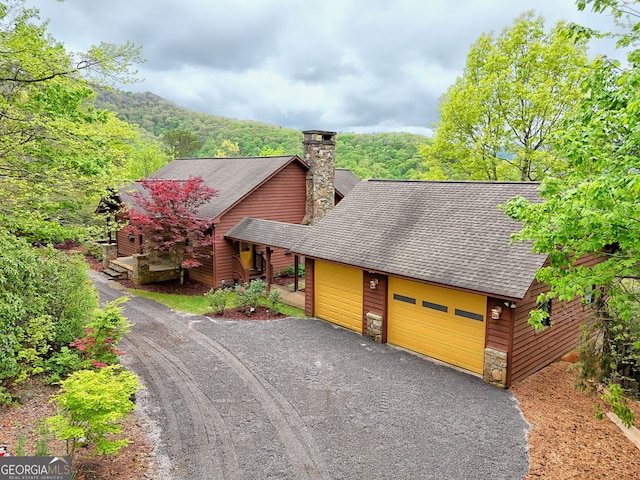 2608 The Rdgs, Hiawassee, GA 30546 - chalet / cabin with a shingled roof, a chimney, driveway, stone siding, and a garage