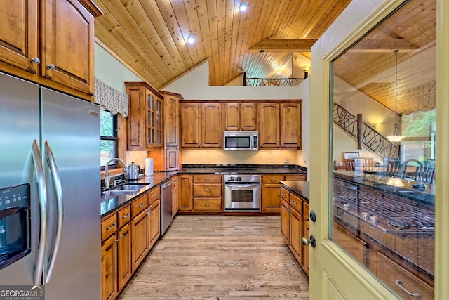 2608 The Rdgs, Hiawassee, GA 30546 - kitchen with stainless steel appliances, a sink, wooden ceiling, brown cabinetry, and light wood finished floors