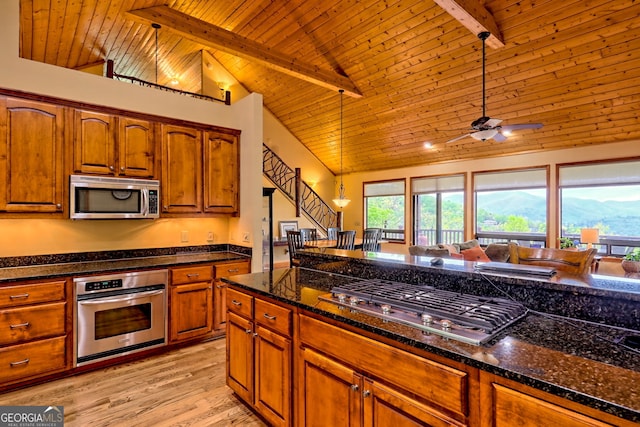 2608 The Rdgs, Hiawassee, GA 30546 - kitchen featuring stainless steel appliances, light wood-style flooring, wood ceiling with exposed beams, brown cabinetry, and a ceiling fan