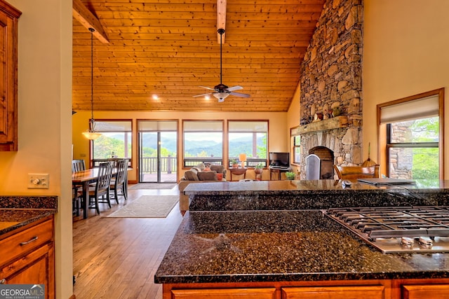 2608 The Rdgs, Hiawassee, GA 30546 - kitchen featuring high vaulted ceiling, wood ceiling with exposed beams, stainless steel gas cooktop, open floor plan, and a fireplace