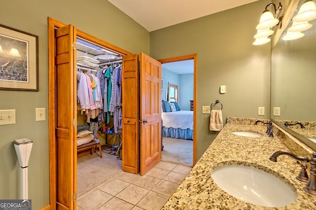 2608 The Rdgs, Hiawassee, GA 30546 - ensuite bathroom with double vanity, tile patterned floors, a chandelier, and a spacious closet