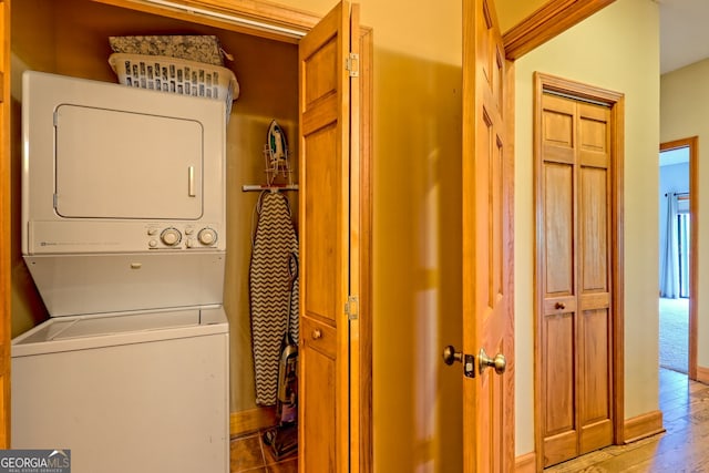 2608 The Rdgs, Hiawassee, GA 30546 - washroom featuring stacked washing machine and dryer, wood finished floors, and baseboards
