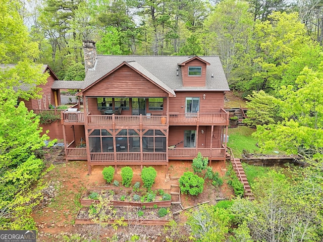 2608 The Rdgs, Hiawassee, GA 30546 - rear view of house featuring a garden, a balcony, a shingled roof, a chimney, and a sunroom