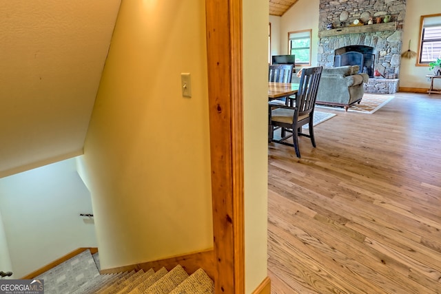2608 The Rdgs, Hiawassee, GA 30546 - stairway featuring vaulted ceiling, wood finished floors, healthy amount of natural light, a stone fireplace, and baseboards