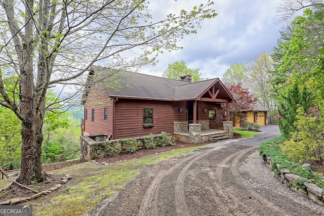2608 The Rdgs, Hiawassee, GA 30546 - chalet / cabin featuring dirt driveway, a chimney, covered porch, and a shingled roof