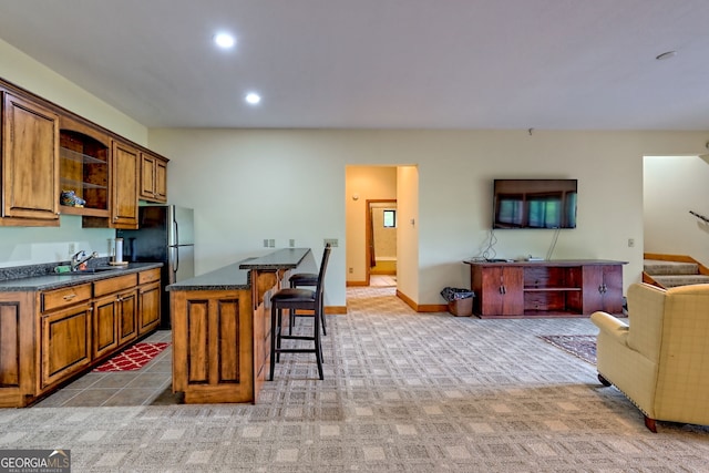 2608 The Rdgs, Hiawassee, GA 30546 - kitchen with a breakfast bar area, brown cabinets, open floor plan, recessed lighting, and a center island
