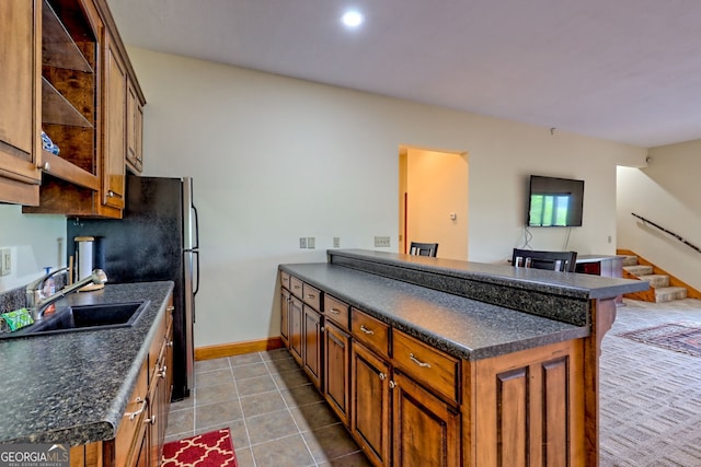 2608 The Rdgs, Hiawassee, GA 30546 - kitchen with a sink, a peninsula, dark countertops, brown cabinets, and tile patterned flooring