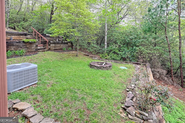 2608 The Rdgs, Hiawassee, GA 30546 - view of grassy yard featuring central air condition unit and a fire pit
