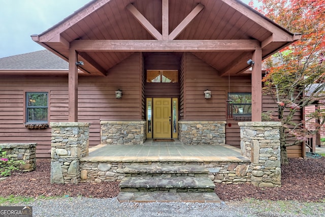 2608 The Rdgs, Hiawassee, GA 30546 - doorway to property with stone siding, covered porch, and roof with shingles