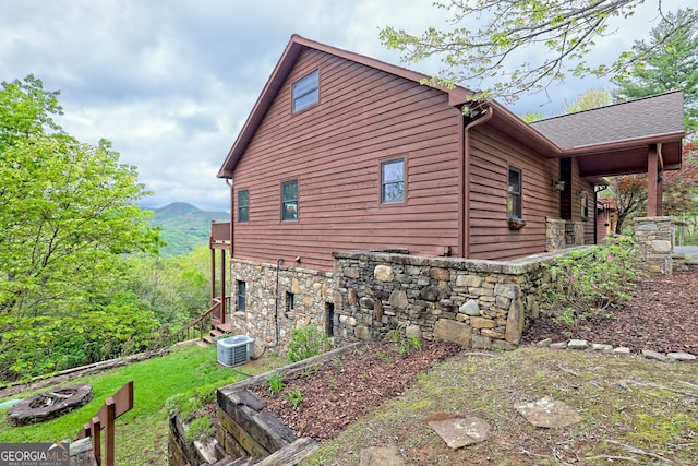 2608 The Rdgs, Hiawassee, GA 30546 - view of side of home featuring stone siding, central AC unit, and a mountain view