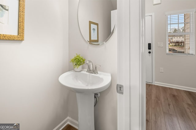 bathroom with baseboards and wood finished floors