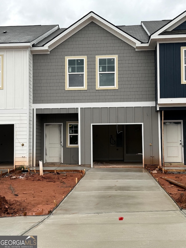 view of front of property with board and batten siding and concrete driveway