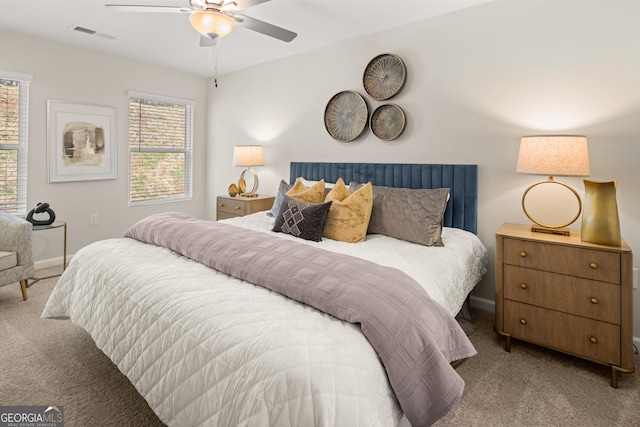 bedroom featuring visible vents, carpet flooring, baseboards, and a ceiling fan