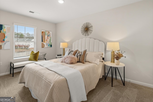 bedroom with visible vents, carpet flooring, and baseboards