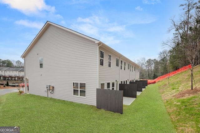 view of side of home with a lawn