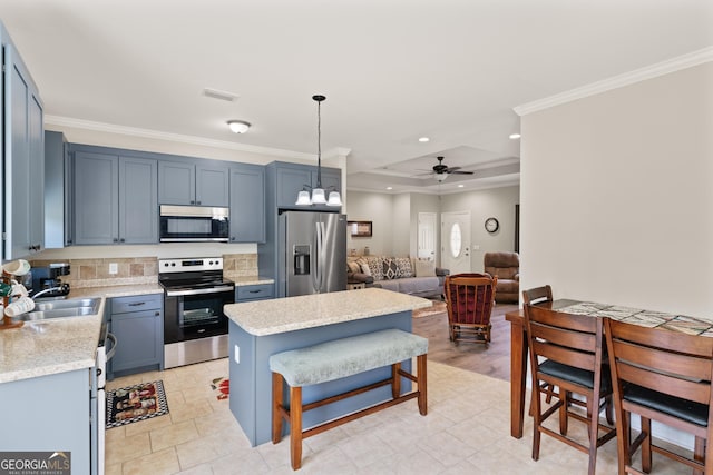 kitchen featuring appliances with stainless steel finishes, light countertops, ornamental molding, a sink, and visible vents