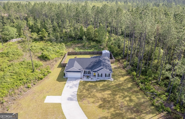 bird's eye view with a wooded view