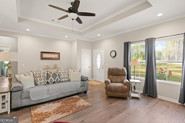 living room with recessed lighting, wood finished floors, ceiling fan, visible vents, and a raised ceiling