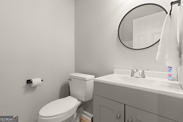 bathroom featuring toilet and vanity